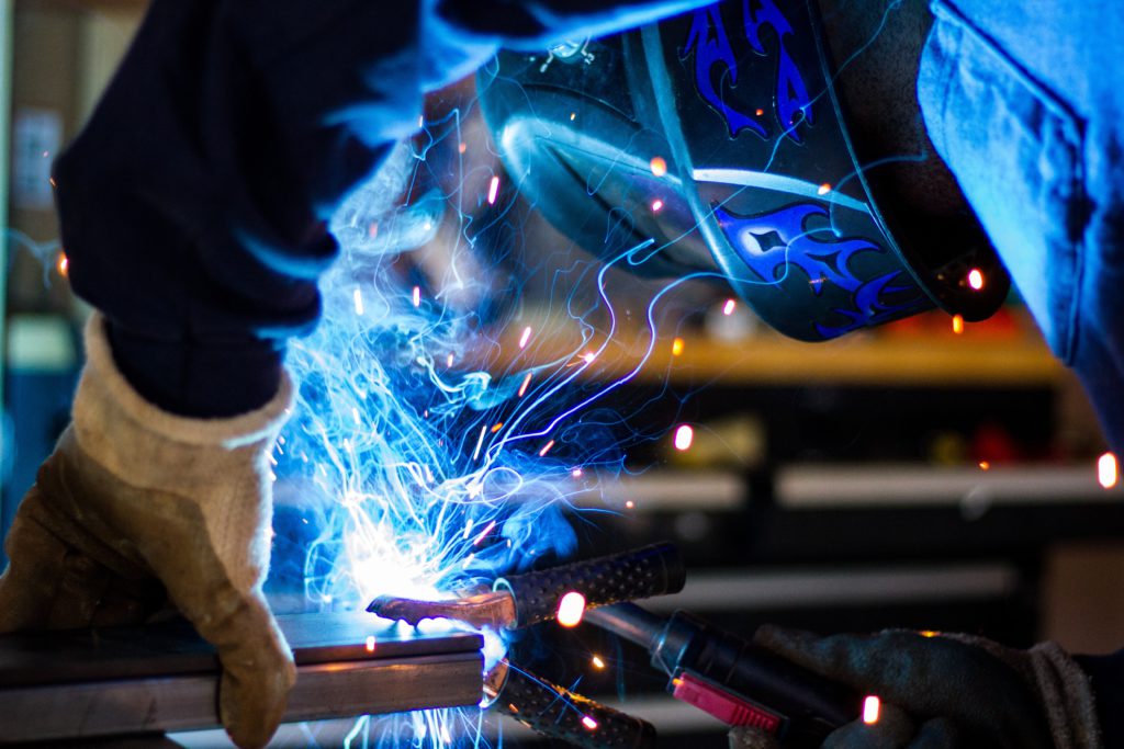 A welder works on a steel frame. Pray a prayer for laborers this Labor Day.