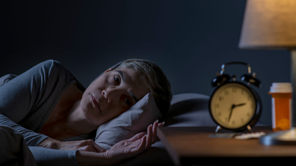 Royalty-free stock photo: A woman strives to trust God on a sleepless night