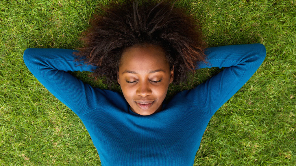 A woman rests on a spring day after feeling weary