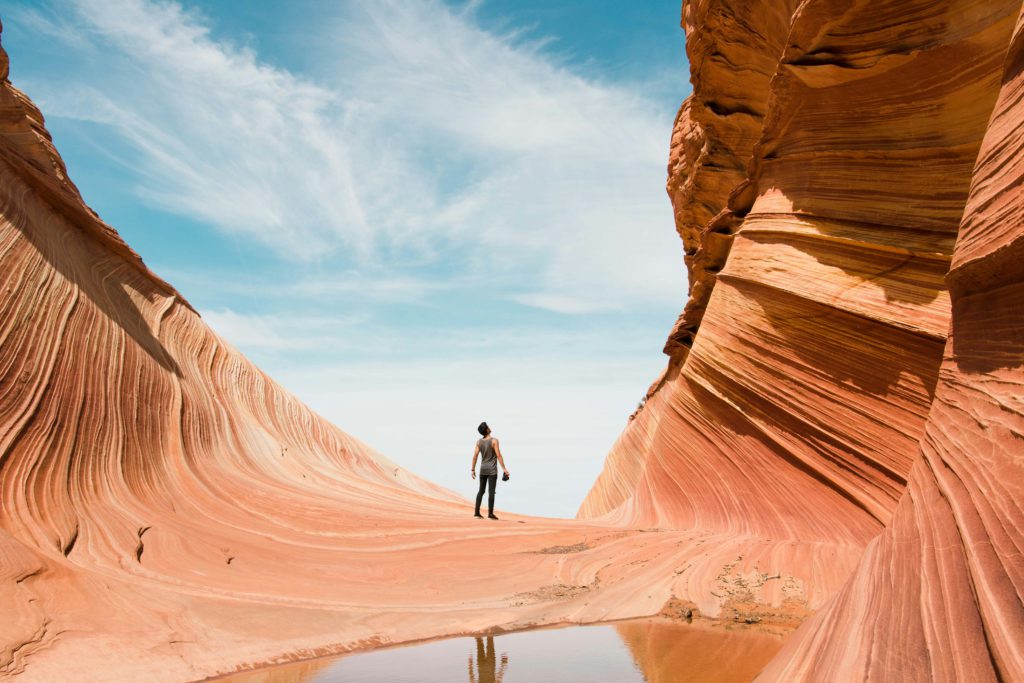 A man stands in awe of the voice of the Lord that created the red rock canyon he stands in.