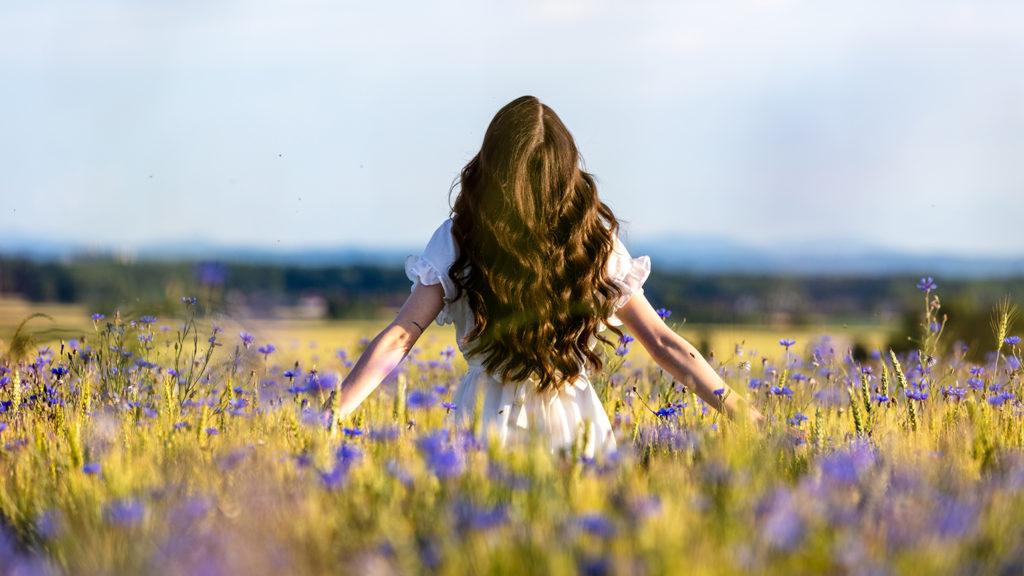 Royalty-Free Stock Photo: Woman embracing truth in a wildflower field.