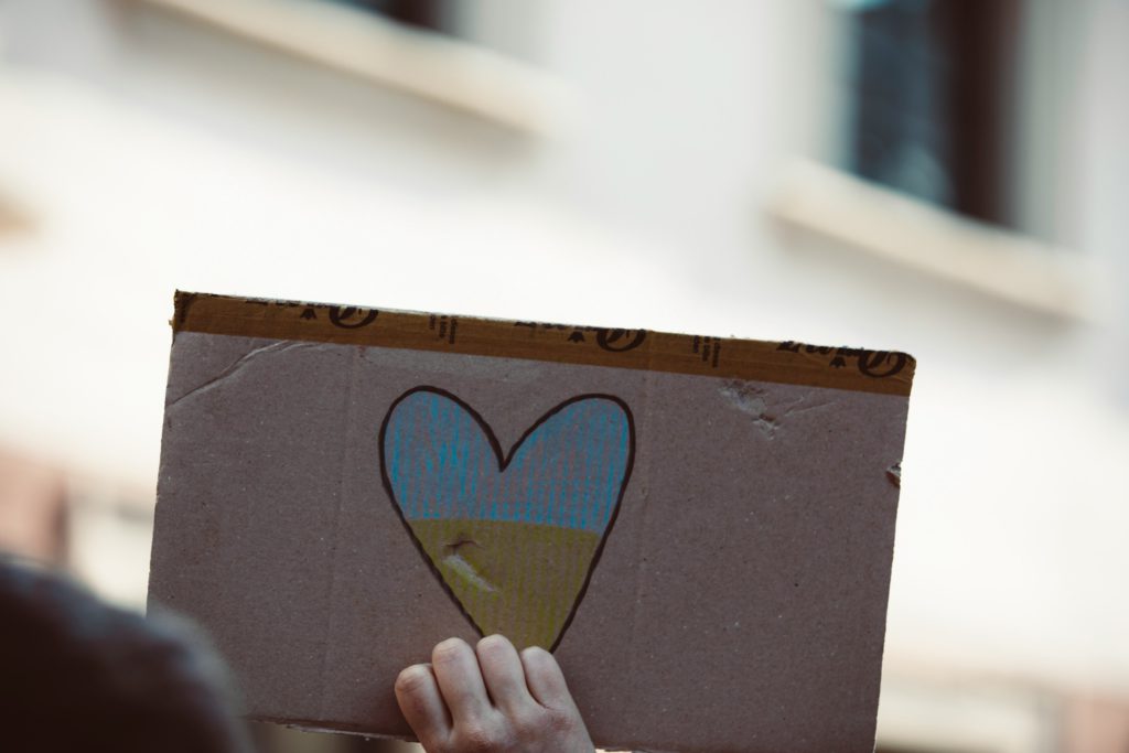 A blue heart drawn on cardboard reminds us to move from wounds to wisdom to become unoffendable.