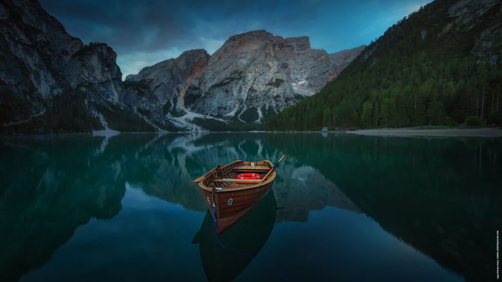 A small boat on a mountain lake reminds us to stay anchored in joy.