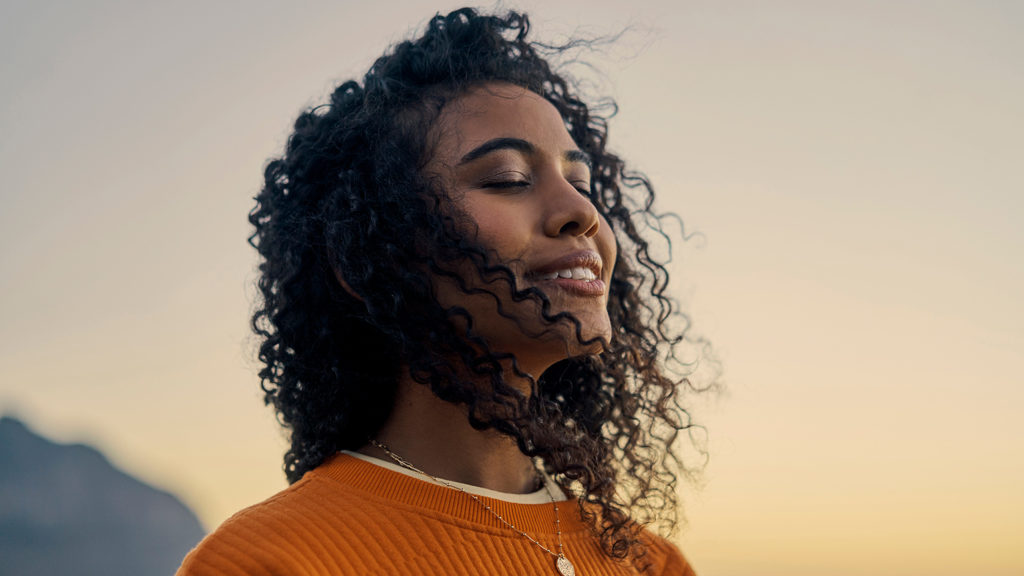 Royalty-Free Stock Photo: Smiling woman learning how to become unoffendable.