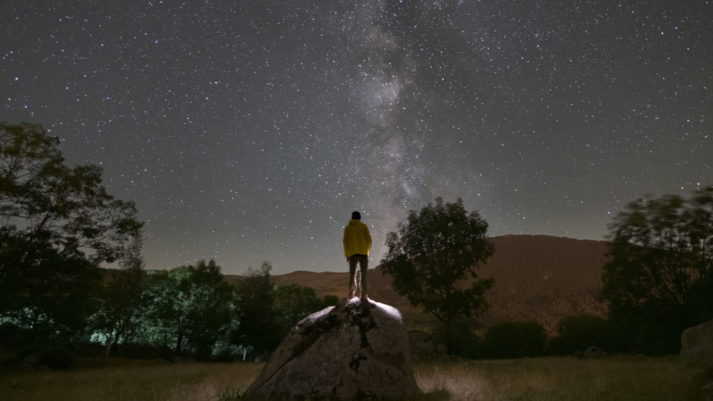 A man stands in silhouette against a night sky knowing he is cherished by the Creator.