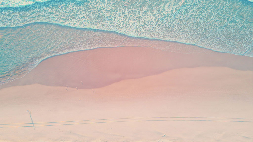 A scene of pink sand and blue water remind us to find our source of contentment in God.