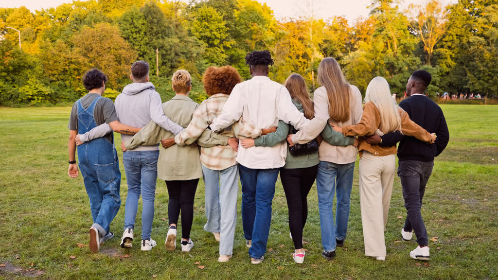 A group of friends hands out at a park as they share deep connections.