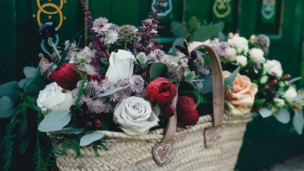 A tote bag full of diverse flowers shows the strength of unity while keeping diversity.