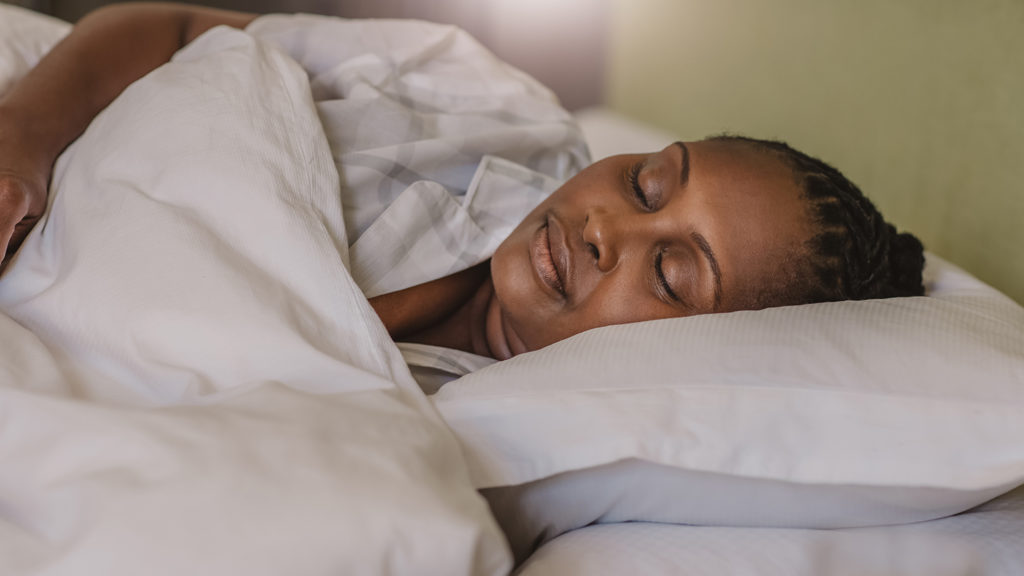 Royalty-free stock image: A woman sleeps peacefully after a guided meditation at bedtime; Getty Images