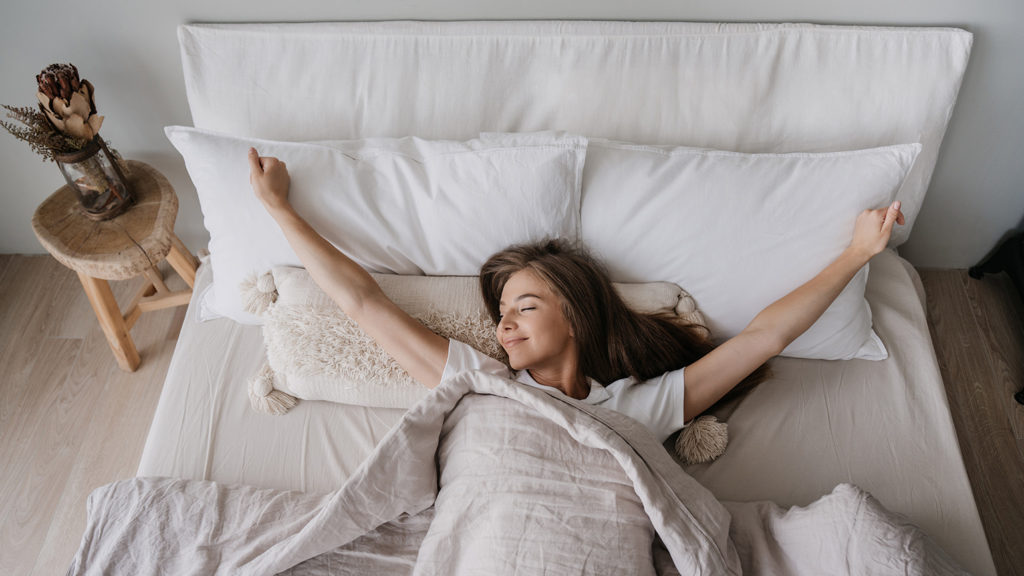 Royalty-Free Stock Photo: Young woman waking up after a good night's sleep.