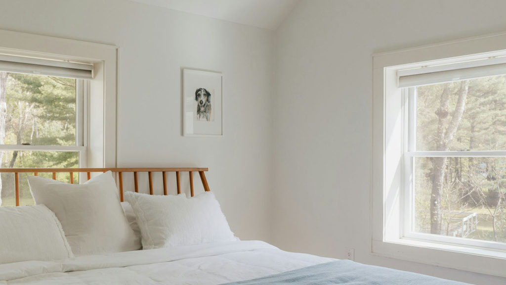 A well-made bed in a peaceful room reminds you to rest from work.